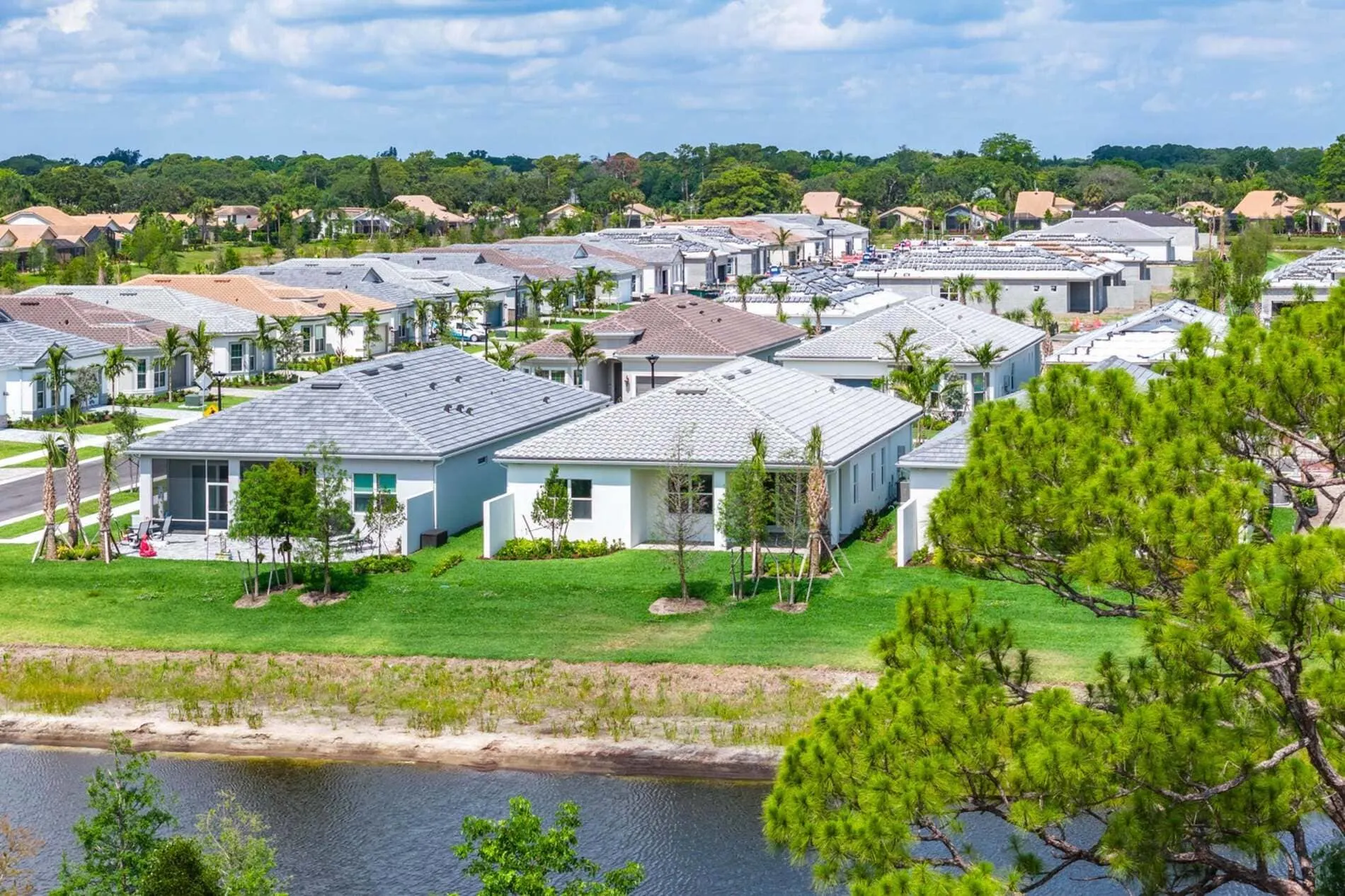 Aerial view of new single-family homes with lakefront lots in Enclave at Sherwood Park, Delray Beach, Florida
